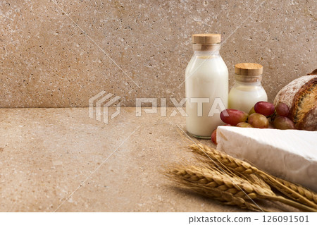Jewish holiday Shavuot concept. Grains, milk and cheese on travertini stone background 126091501