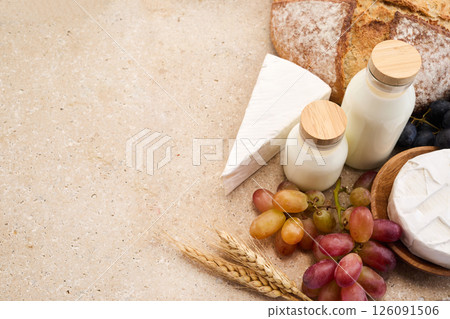 Jewish holiday Shavuot concept. Grains, milk and cheese on travertini stone background Jewish holiday Shavuot concept. Grains, milk and cheese on travertini stone background 126091506