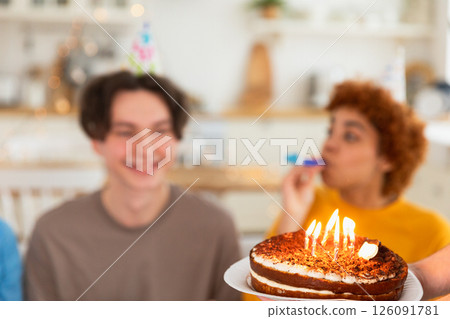 Make a wish. Burning candles on birthday cake ready for blowing out. Happy Birthday party. Friends wishes man happy birthday. People celebrating birthday party. Plate with birthday cake in hands Make a wish. Burning candles on birthday cake ready for blowing out. Happy Birthday party. Friends wishes man happy birthday. People celebrating birthday party. Plate with birthday cake in hands 126091781