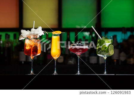 row of various colourfull alcoholic cocktails on a bar desk. Glasses of differen shapes 126091983