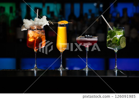 row of various colourfull alcoholic cocktails on a bar desk. Glasses of differen shapes 126091985