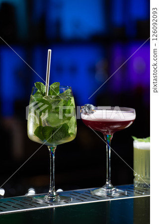 row of various colourfull alcoholic cocktails on a bar desk. Glasses of differen shapes. selective focus 126092093