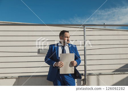 Businessman Wearing A Blue Suit Working Outdoor In The Morning  126092282