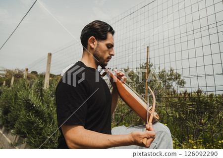 Lyre Player Feeling Inspired By The Nature  126092290