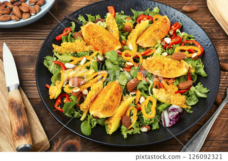 Salad of cactus fruits, peppers and almonds. 126092321