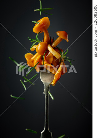 Pickled honey mushrooms sprinkled with rosemary. 126092606