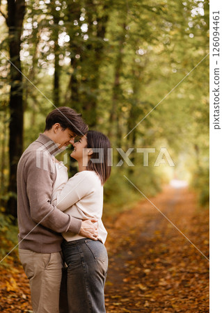 Happy couple embracing in autumn forest. Copy space. Happy couple embracing in autumn forest. Copy space. 126094461