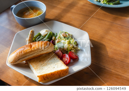 Morning sunlight and a western breakfast plate full of vegetables Morning sunlight and a western breakfast plate full of vegetables 126094549