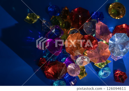Colorful gemstones and crystals in various shapes on a vibrant blue background. Colorful gemstones and crystals in various shapes on a vibrant blue background. 126094611