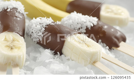 Chocolate Covered Banana Pops with Coconut Flakes 126095435