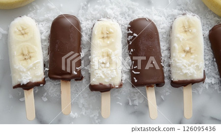 Frozen Banana Popsicles Dipped in Chocolate and Coconut 126095436