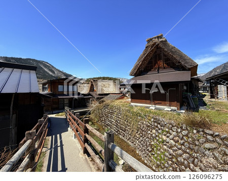 Shirakawa-go is historic village in Gifu Prefecture, famous for its gassho-zukuri farmhouses with steep thatched roofs, a UNESCO World Heritage Site. Shirakawa-go is historic village in Gifu Prefecture, famous for its gassho-zukuri farmhouses with steep thatched roofs, a UNESCO World Heritage Site. 126096275