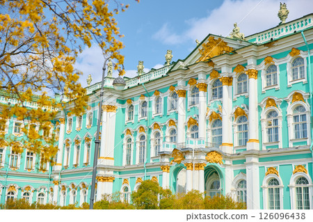 the incredibly picturesque facade of the Winter Palace through the branches of trees on a clear spring day, the heritage of Russia, the most famous landmark of St. Petersburg, the museum the incredibly picturesque facade of the Winter Palace through the branches of trees on a clear spring day, the heritage of Russia, the most famous landmark of St. Petersburg, the museum 126096438