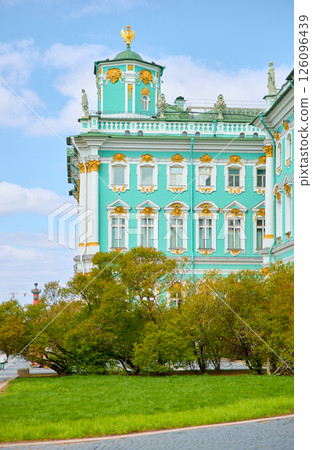 the incredibly picturesque facade of the Winter Palace through the branches of trees on a clear spring day, the heritage of Russia, the most famous landmark of St. Petersburg, the museum the incredibly picturesque facade of the Winter Palace through the branches of trees on a clear spring day, the heritage of Russia, the most famous landmark of St. Petersburg, the museum 126096439