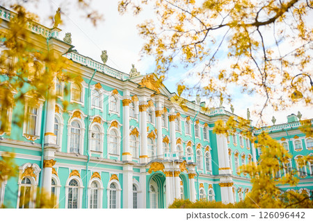 the incredibly picturesque facade of the Winter Palace through the branches of trees on a clear spring day, the heritage of Russia, the most famous landmark of St. Petersburg, the museum the incredibly picturesque facade of the Winter Palace through the branches of trees on a clear spring day, the heritage of Russia, the most famous landmark of St. Petersburg, the museum 126096442