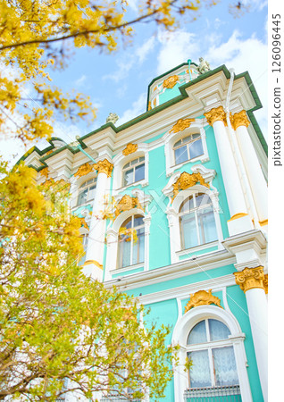 the incredibly picturesque facade of the Winter Palace through the branches of trees on a clear spring day, the heritage of Russia, the most famous landmark of St. Petersburg, the museum the incredibly picturesque facade of the Winter Palace through the branches of trees on a clear spring day, the heritage of Russia, the most famous landmark of St. Petersburg, the museum 126096445