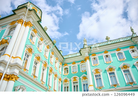 the incredibly picturesque facade of the Winter Palace through the branches of trees on a clear spring day, the heritage of Russia, the most famous landmark of St. Petersburg, the museum 126096449