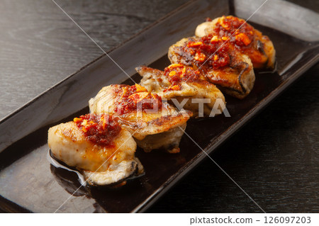 Grilled oysters with chili sauce 126097203