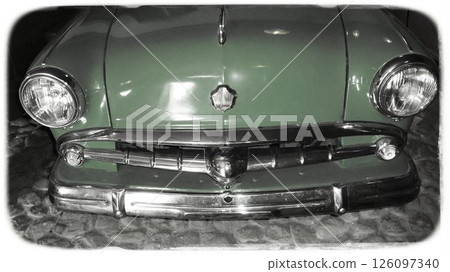The front of a vintage green car rests on a cobblestone street, illuminated by soft light. The shiny chrome details reflect the surrounding ambiance, emphasizing its classic design. The front of a vintage green car rests on a cobblestone street, illuminated by soft light. The shiny chrome details reflect the surrounding ambiance, emphasizing its classic design. 126097340