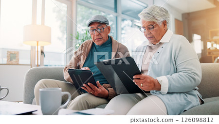 Senior couple, tablet and clipboard at house for finance planning, review bills and payment checklist. Elderly people, digital and document for investment, insurance application and asset management 126098812