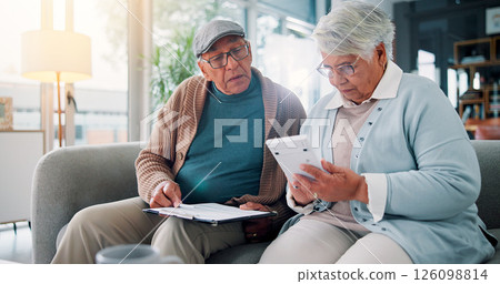 Senior couple, calculator and documents on couch with finance, budget and review for bills in retirement. People, paperwork and partner with problem solving for wealth, saving or investing in home 126098814