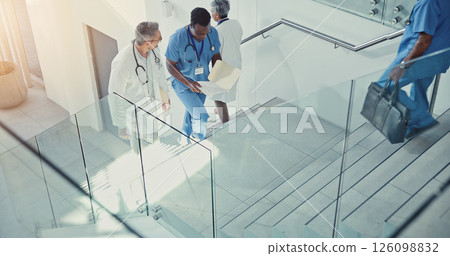 Paperwork, doctor and nurse walk on stairs with documents in hospital lobby. Above discussion, medical professional men on steps with files for healthcare, teamwork and collaboration in clinic 126098832