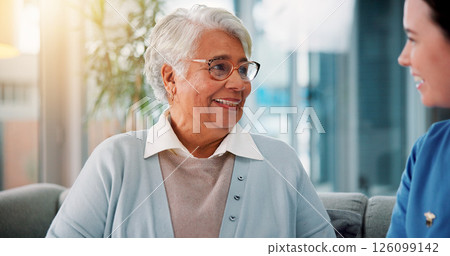 Senior, woman and nurse on sofa in retirement home for healthcare support, medical service and conversation. Elderly person, caregiver and happy for homecare assistance, kindness and friendly chat 126099142