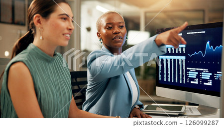 Computer, night and pointing with business women in office together for stock market trading. Conversation, feedback or screen with employee people in workplace for investment or portfolio management Computer, night and pointing with business women in office together for stock market trading. Conversation, feedback or screen with employee people in workplace for investment or portfolio management 126099287