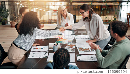 Business people, meeting and handshake for team with applause, praise or congratulations at creative agency. Market research, paperwork and female employees shaking hands for well done or success Business people, meeting and handshake for team with applause, praise or congratulations at creative agency. Market research, paperwork and female employees shaking hands for well done or success 126099394