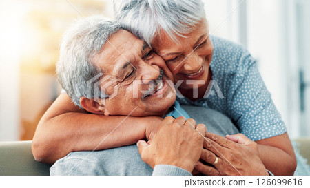 Bonding, hug and senior couple in home, smile and commitment for relationship, love and relax in lounge. House, old man and care for woman in living room, embrace and retirement for elderly people 126099616