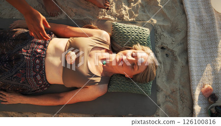 Woman, crystal and therapy at beach with chakra balance, energy and healing with rest on vacation. Person, stone and holistic care with mineral, mindfulness and shaman with zen on ground in summer 126100816