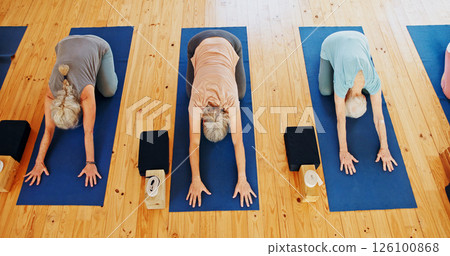 Above, senior and people stretching in yoga class for fitness, exercise and spiritual wellness. Group, elderly women and childs pose for pilates lesson, community and holistic balance at health club Above, senior and people stretching in yoga class for fitness, exercise and spiritual wellness. Group, elderly women and childs pose for pilates lesson, community and holistic balance at health club 126100868