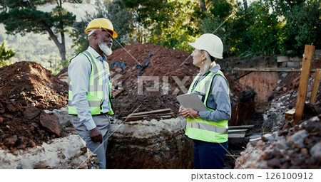 Engineering, people and meeting on construction site with tablet, discussion and problem solving in foundation. Woman inspector, mature team and tech on worksite with planning for project management 126100912