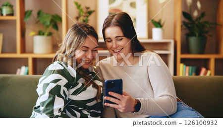 Mature woman, daughter and smartphone in house for bonding, watching video or social media post online. Home, mothers day and happy female people with mobile app, streaming or funny meme on internet Mature woman, daughter and smartphone in house for bonding, watching video or social media post online. Home, mothers day and happy female people with mobile app, streaming or funny meme on internet 126100932