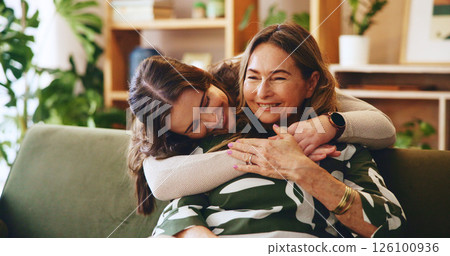 Hug, smile or visit with mother and daughter on sofa in living room of home for bonding or love. Happy, safety and security with family embracing in apartment together for relax, support or trust 126100936