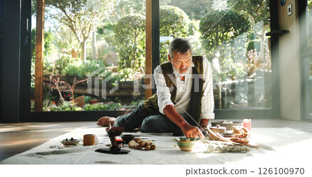Incense, alternative medicine and Asian man on floor for spiritual meditation, holistic treatment and healing. Aromatherapy, cleanse and healer with stones for peace, chakra and detox for wellness 126100970
