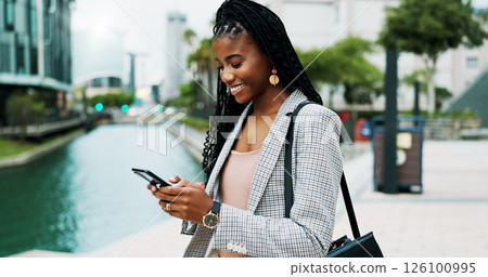 Happy, business and African woman with phone in city for morning commute, trip and travel to office. Professional, corporate and person on smartphone for networking, connection and internet in town 126100995