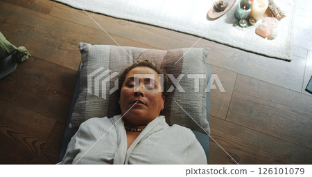 Relax, zen and woman at guided meditation class for mindfulness, peace and balance practice. Above, yoga nidra and female person at somatic healing session for wellness, health or trauma release. 126101079
