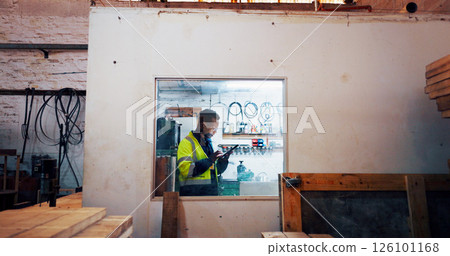 Man, tablet and job at warehouse, industry and scroll with typing report at lumber plant. African person, carpenter and digital touchscreen on application for wood, material or stock order at factory Man, tablet and job at warehouse, industry and scroll with typing report at lumber plant. African person, carpenter and digital touchscreen on application for wood, material or stock order at factory 126101168