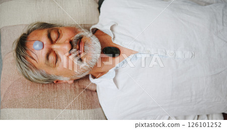 Crystal, meditation and peace with Asian man on floor for energy balance, healing ritual or spirituality. Chakra, zen or holistic with above of senior person for aura cleanse and wellness ceremony 126101252