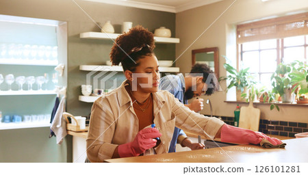 Woman, cloth and cleaning with spray by kitchen counter in home with partner, gloves or routine in morning. People, relationship and ppe with chemical for bacteria, germs or disinfectant at apartment 126101281