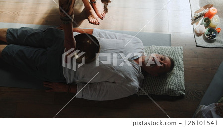 Hands, person and bowl for Tibetan singing with man for healing, sound ritual and holistic practice. Healer, soul music and metal instrument of natural meditation, spiritual mantra and chakra balance Hands, person and bowl for Tibetan singing with man for healing, sound ritual and holistic practice. Healer, soul music and metal instrument of natural meditation, spiritual mantra and chakra balance 126101541