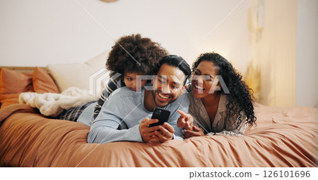 Happy family, relax and laughing with phone on bed for funny joke, meme or social media at home. Mom, dad and child with smile for comedy, humor or online entertainment on mobile smartphone at house Happy family, relax and laughing with phone on bed for funny joke, meme or social media at home. Mom, dad and child with smile for comedy, humor or online entertainment on mobile smartphone at house 126101696