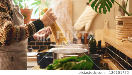 Cooking, hands and spaghetti with person in kitchen of home for boiling or meal preparation. Food, gas stove or pasta and chef in apartment with ingredients or recipe for diet, health and nutrition Cooking, hands and spaghetti with person in kitchen of home for boiling or meal preparation. Food, gas stove or pasta and chef in apartment with ingredients or recipe for diet, health and nutrition 126101723