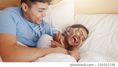 Love, tickle and couple laughing in bed together for morning affection, bonding or wake up. Excited, cuddle or joke with man and happy woman in apartment for funny humor, marriage or relationship Love, tickle and couple laughing in bed together for morning affection, bonding or wake up. Excited, cuddle or joke with man and happy woman in apartment for funny humor, marriage or relationship 126101748