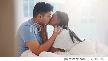 Couple, kiss and love in bed together, affection and bonding with commitment for trust at home. Romance, partner and security in healthy relationship with intimacy or interracial people in bedroom 126101760