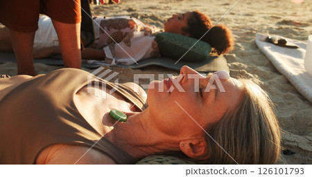 Woman, crystal and ground at beach with chakra balance, therapy and outdoor for healing on vacation. People, stone and holistic with mineral, mindfulness and care with energy for zen in summer 126101793