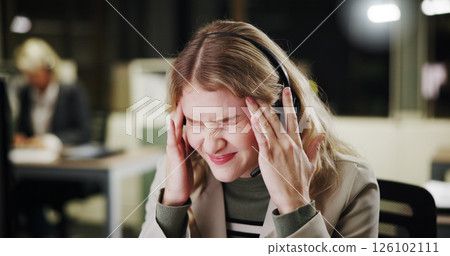 Pain, stress or woman with headache in call center for sales deadline or customer service on break. Night, consultant and exhausted agent in telecom office with fatigue, migraine and burnout crisis Pain, stress or woman with headache in call center for sales deadline or customer service on break. Night, consultant and exhausted agent in telecom office with fatigue, migraine and burnout crisis 126102111