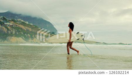 Girl, surfboard and walk at beach with waves for water sports, hobby and outdoor in morning on holiday. Woman, surfer and happy for training, fitness and start with exercise by ocean in Costa Rica 126102214