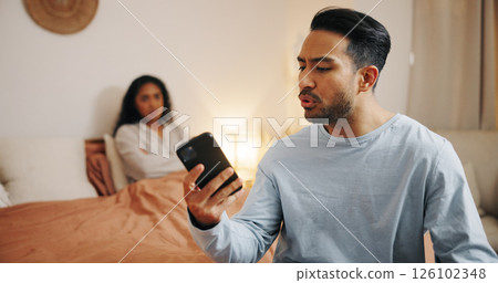Frustrated couple, phone and bed with fight for cheating affair, trust issues or argument at home. Upset, man or woman with mobile smartphone in bedroom for toxic relationship, conflict or divorce 126102348